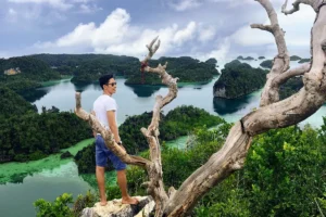 Traveler visiting Arborek Village in Raja Ampat, experiencing local Papuan culture